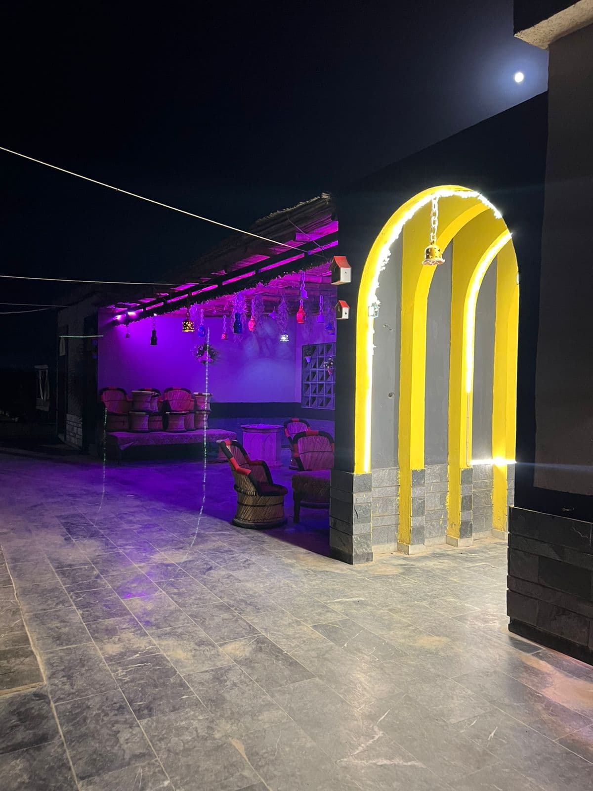 Moonlit night view of the estate entrance archway and lounge