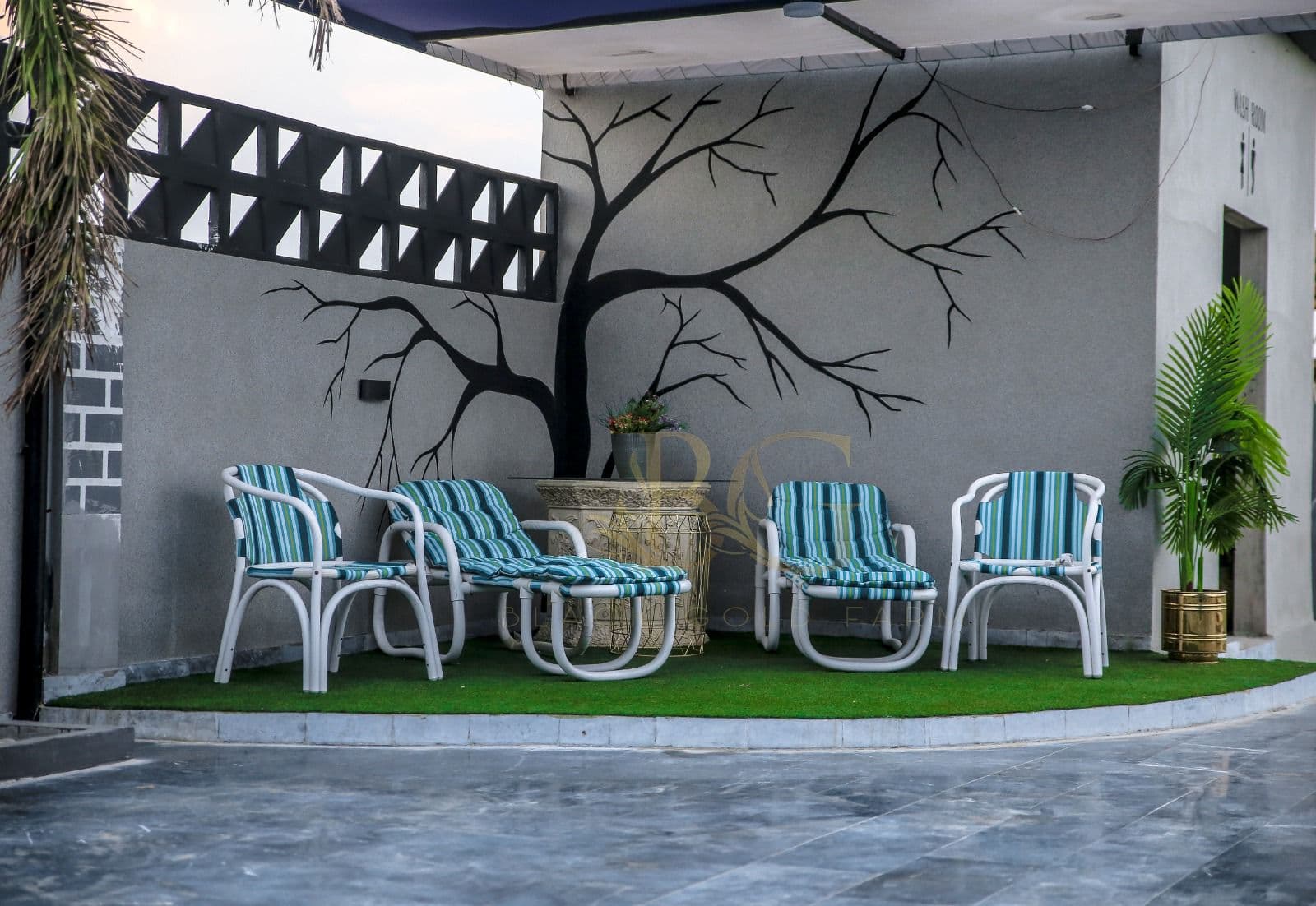 Poolside Miami lounge chairs with custom tree wall mural