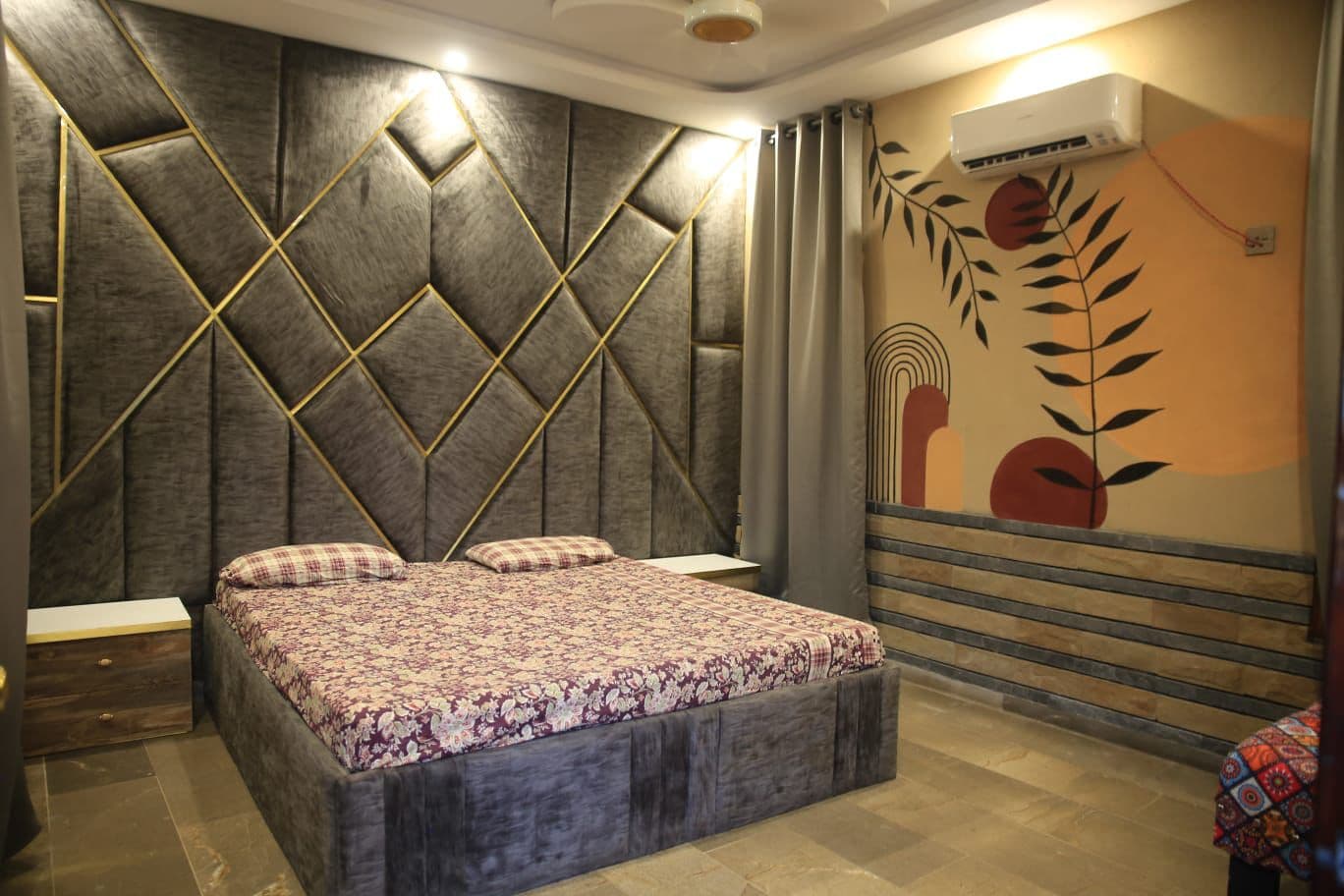 Luxurious AC bedroom suite with velvet headboard
